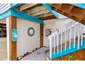 Quaint entryway with wooden stairs, beach decor, and seashells at 5031 N Beach Rd # 112, Englewood, FL 34223