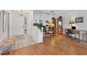 Bright entryway with wood flooring, bench, and home office area at 610 Apple Ln, Englewood, FL 34223