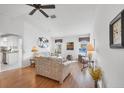Comfortable living room featuring hardwood floors and ample natural light at 610 Apple Ln, Englewood, FL 34223