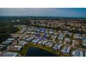 Wide aerial view showcasing the home's neighborhood and proximity to water at 808 Tangerine Woods Blvd, Englewood, FL 34223