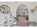 Elegant entryway with a large mirror and view to living room at 926 Boundary Blvd, Rotonda West, FL 33947