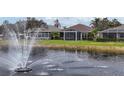 Lake view with fountain and houses at 9507 Carnaby Dr, Venice, FL 34293