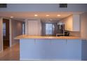 The open kitchen features modern appliances and a convenient breakfast bar, great for entertaining at 9700 Fiddlers Green Cir # 117, Rotonda West, FL 33947