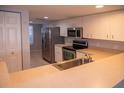 This stylish kitchen has stainless steel appliances, ample cabinet space, and a functional layout at 9700 Fiddlers Green Cir # 117, Rotonda West, FL 33947