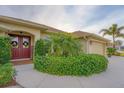 Home features a double-door entry and mature landscaping at 1 Sportsman Ter, Rotonda West, FL 33947