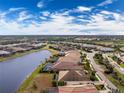 Aerial view of a house and its surroundings in a residential community at 10820 Trophy Dr, Englewood, FL 34223