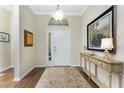 Bright and spacious entryway with hardwood floors and decorative accents at 10820 Trophy Dr, Englewood, FL 34223