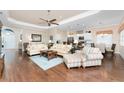 Open living room featuring hardwood floors and ample natural light at 10820 Trophy Dr, Englewood, FL 34223