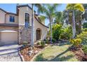 Two-story house with a stone facade and lush landscaping at 117 Cable Dr, Rotonda West, FL 33947