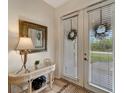 Bright and airy entryway with glass-top console table at 13235 Essman Ave, Port Charlotte, FL 33953