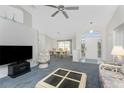 Bright living room with carpet flooring, a TV, and dining area at 152 Sportsman Rd, Rotonda West, FL 33947