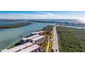 Aerial view showcasing the condo complex with surrounding roads and waterfront access at 1701 Beach Rd # 404, Englewood, FL 34223