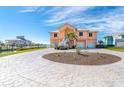 Two-story waterfront home with a circular driveway and mature landscaping at 1901 Illinois Ave, Englewood, FL 34224