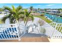 White railing staircase leading down from the house to the waterfront at 1901 Illinois Ave, Englewood, FL 34224