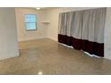 Bright living room with a window and terrazzo flooring at 21179 Glendale Ave, Port Charlotte, FL 33952