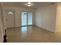 Living room with sliding glass doors and terrazzo flooring at 21179 Glendale Ave, Port Charlotte, FL 33952