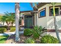 Front entrance with decorative columns and lush landscaping at 214 W Pine Valley Ln, Rotonda West, FL 33947