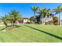 Attractive home with palm trees and well-manicured lawn at 214 W Pine Valley Ln, Rotonda West, FL 33947