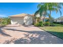 Two-story house with a two-car garage and manicured lawn at 2619 Myakka Marsh Ln, Port Charlotte, FL 33953