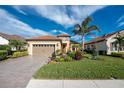 Attractive single-story home with a tile roof, landscaping, and a two-car garage at 26744 Weiskopf Dr, Englewood, FL 34223