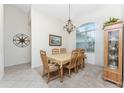 Formal dining room with wooden table and chairs, plus a large window at 276 Long Meadow Ln, Rotonda West, FL 33947