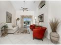 Bright living room with tiled floors, comfy seating, and access to the pool at 276 Long Meadow Ln, Rotonda West, FL 33947