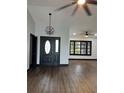 Modern entryway with dark hardwood floors and a chandelier at 294 Rotonda Cir, Rotonda West, FL 33947