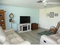 Bright living room featuring comfy sofas, a fireplace, and wood-look floors at 3159 Pinetree St, Port Charlotte, FL 33952