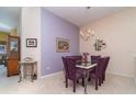 Dining area with purple accent wall and a chandelier illuminating the table at 3323 Grand Vista Ct # 201, Port Charlotte, FL 33953