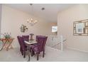 Dining room features a chandelier and a table with purple chairs at 3323 Grand Vista Ct # 201, Port Charlotte, FL 33953