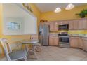 Kitchen features stainless steel appliances and breakfast nook at 3353 Grand Vista Ct # 202, Port Charlotte, FL 33953