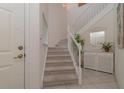 Bright and airy entryway with carpeted staircase and storage at 3353 Grand Vista Ct # 202, Port Charlotte, FL 33953