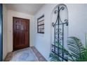 Inviting entryway with wood door, tile flooring, and wrought iron accents at 367 Englewood Isles Pkwy # 4, Englewood, FL 34223