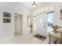 Bright foyer with tiled flooring and a transom window above the front door at 40 Bunker Pl, Rotonda West, FL 33947