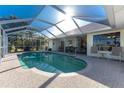 Enclosed swimming pool with lanai seating area offers an outdoor living space at 40 Bunker Pl, Rotonda West, FL 33947