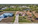 Two houses, one light blue, one tan, visible from above at 411 Boundary Blvd, Rotonda West, FL 33947