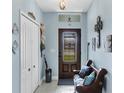 Inviting entryway featuring blue walls, decorative accents, and natural light streaming through the front door at 429 Rotonda Cir, Rotonda West, FL 33947