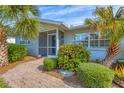 Inviting front entry with a brick walkway and lush landscaping at 5292 Early Ter, Port Charlotte, FL 33981