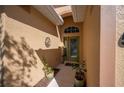 Inviting entryway with a custom metal house number and potted plants at 5560 Club View Ln, North Port, FL 34287