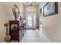 Bright foyer featuring a wooden console table and decorative accents at 5560 Club View Ln, North Port, FL 34287