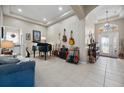 Spacious living room with a grand piano and multiple guitars at 5560 Club View Ln, North Port, FL 34287