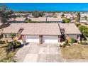 Aerial perspective of two-unit villa with attached garages and neatly landscaped surroundings at 615 Apple Ln, Englewood, FL 34223