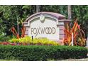 Foxwood community sign with lush landscaping; inviting entrance to the neighborhood at 615 Apple Ln, Englewood, FL 34223