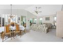 Spacious living room with floral sofas, a coffee table, and a view into the dining area at 615 Apple Ln, Englewood, FL 34223