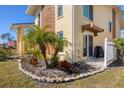 Landscaped yard with palm trees and a stone border at 6699 San Casa Dr # T1, Englewood, FL 34224