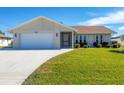 Single-story home with attached garage and landscaped yard at 7398 Spinnaker Blvd, Englewood, FL 34224