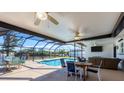 Lush pool area with patio furniture and canal view at 7398 Spinnaker Blvd, Englewood, FL 34224