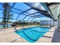 Relaxing screened-in pool with water view at 7398 Spinnaker Blvd, Englewood, FL 34224