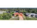 Single-story house with red tile roof, situated in a quiet residential neighborhood at 7438 Banbury Ter, Port Charlotte, FL 33981