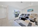 Bright living room with tiled floors, comfy seating, and a bay window at 7438 Banbury Ter, Port Charlotte, FL 33981